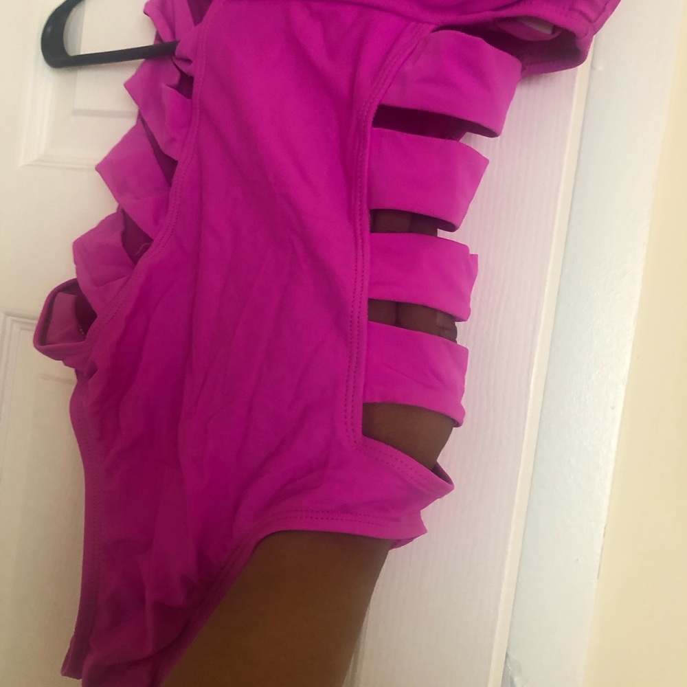 One piece fuscia swimsuit with cut out sides